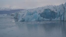 4K aerial stock footage flying low over a lake, panning right past a glacier, Knik, Alaska Aerial Stock Footage | AK0001_0050