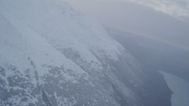 4K aerial stock footage approach shoreline of lake, reveal Chugach Mountains, Eklutna Lake, Alaska Aerial Stock Footage | AK0001_0073