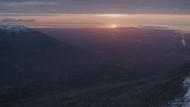 4K aerial stock footage snow covered slope, revealing Anchorage, Chugach Mountains, Alaska, sunset Aerial Stock Footage | AK0001_0094