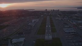 4K aerial stock footage flying over Merrill Field, approaching Downtown Anchorage, Alaska, sunset Aerial Stock Footage | AK0001_0105