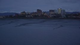 4K aerial stock footage flying over Knik Arm of Cook Inlet approaching Downtown Anchorage, Alaska, night Aerial Stock Footage | AK0001_0154