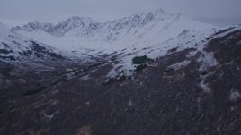 4K aerial stock footage fly over foothills, approach snow covered peaks, Chugach Mountains, Alaska, twilight Aerial Stock Footage | AK0001_0186