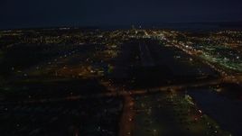 4K aerial stock footage approaching Merrill Field, landing aircraft, Anchorage, Alaska, night Aerial Stock Footage | AK0001_0197