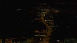 4K aerial stock footage flying over street lined with shops, Anchorage, Alaska, night Aerial Stock Footage | AK0001_0200