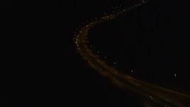 4K aerial stock footage following Glenn Highway, tilt up to Anchorage, Alaska, night Aerial Stock Footage | AK0001_0203