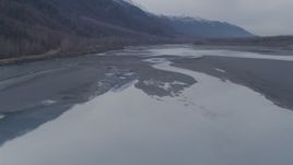 4K aerial stock footage flying along the river, approaching Chugach Mountains, Knik River, Alaska Aerial Stock Footage | AK0001_0217