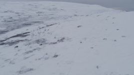 4K aerial stock footage flying low over snow covered slopes, Chugach Mountains, Alaska Aerial Stock Footage | AK0001_0235