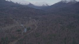 4K aerial stock footage fly over forested foothills, reveal Chugach Mountains, Fort Richardson, Anchorage Aerial Stock Footage | AK0001_0248