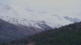 4K aerial stock footage flying around a slope, revealing snow capped peaks, Chugach Mountains, Alaska Aerial Stock Footage | AK0001_0251