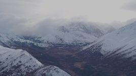 4K aerial stock footage fly past snow covered, cloud capped peaks of the Chugach Mountains, Alaska Aerial Stock Footage | AK0001_0257