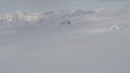 4K aerial stock footage pan left across snow covered valley, peaks, Chugach Mountains, Alaska Aerial Stock Footage | AK0001_0273