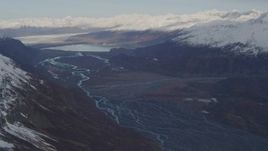 4K aerial stock footage flying over a river valley, pan right to reveal a glacier, Inner Lake George, Alaska Aerial Stock Footage | AK0001_0279