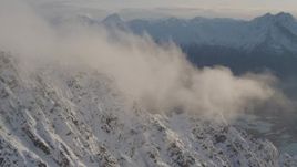 4K aerial stock footage snowy slopes, clouds, Knik River Valley, Knik Glacier, Chugach Mountains, Alaska Aerial Stock Footage | AK0001_0296
