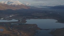 4K aerial stock footage flying over lakes and rivers, tilt up to reveal Knik River Valley, Alaska Aerial Stock Footage | AK0001_0299