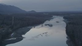 4K aerial stock footage flying along the Knik River, tilt down, Knik River, Alaska, sunset Aerial Stock Footage | AK0001_0305
