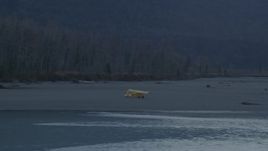 4K aerial stock footage orbiting a small plane parked on shore of the river, Knik River, Alaska, twilight Aerial Stock Footage | AK0001_0309