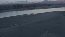 4K aerial stock footage orbiting a small plane readying for takeoff on the shore, Knik River, Alaska, sunset Aerial Stock Footage | AK0001_0311