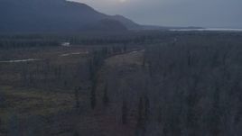 4K aerial stock footage fly over forest, veer over river bend, approach hills, Knik River, Alaska, twilight Aerial Stock Footage | AK0001_0312