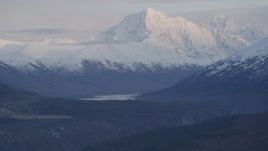 4K aerial stock footage flying by snow capped mountain peak, Chugach Mountains, Alaska, twilight Aerial Stock Footage | AK0001_0318