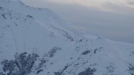 4K aerial stock footage approaching snow covered peaks, Chugach Mountains, Alaska, twilight Aerial Stock Footage | AK0001_0322