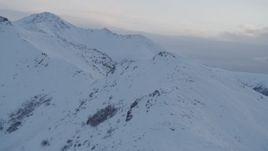 4K aerial stock footage fly over snowy peak, approach second peak, Chugach Mountains, Alaska, twilight Aerial Stock Footage | AK0001_0323