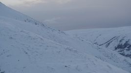 4K aerial stock footage approaching snow covered slope, Chugach Mountains, Alaska, twilight Aerial Stock Footage | AK0001_0326