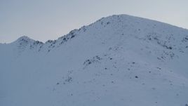4K aerial stock footage fly up snowy slope, approach summit, Chugach Mountains, Alaska, twilight Aerial Stock Footage | AK0001_0327