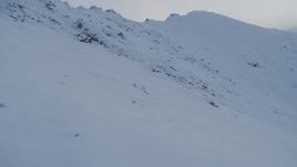 4K aerial stock footage flying over snowy slopes, Chugach Mountains, Alaska, twilight Aerial Stock Footage | AK0001_0328