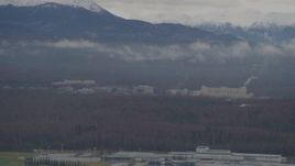 4K aerial stock footage flying by office buildings, scattered low clouds, Anchorage, Alaska Aerial Stock Footage | AK0001_0336