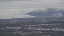 4K aerial stock footage flying by neighborhoods, Chugach Mountains in the distance, Anchorage, Alaska Aerial Stock Footage | AK0001_0337
