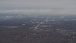 4K aerial stock footage flying by Anchorage with low lying clouds, Anchorage, Alaska Aerial Stock Footage | AK0001_0341