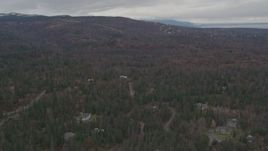 4K aerial stock footage flying over forested foothills, approaching neighborhood, Anchorage, Alaska Aerial Stock Footage | AK0001_0342
