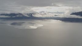 4K aerial stock footage snowy Kenai Mountains, sunlit clouds, the Turnagain Arm of the Cook Inlet, Alaska Aerial Stock Footage | AK0001_0351