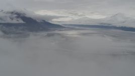4K aerial stock footage descending through clouds, approach Turnagain Arm of the Cook Inlet, Alaska Aerial Stock Footage | AK0001_0354