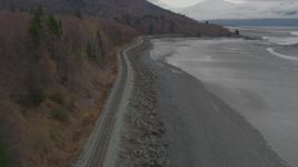 4K aerial stock footage follow railroad tracks along shore of Turnagain Arm of the Cook Inlet, Alaska Aerial Stock Footage | AK0001_0357