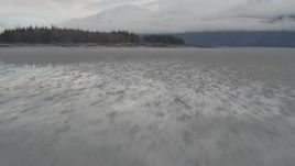 4K aerial stock footage fly low over water, rocky peninsula, Turnagain Arm of the Cook Inlet, Alaska Aerial Stock Footage | AK0001_0363