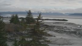 4K aerial stock footage flying low over rocks, trees and beach, Turnagain Arm of the Cook Inlet, Alaska Aerial Stock Footage | AK0001_0364
