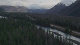 4K aerial stock footage flying low over forest, revealing river, Portage Glacier Road, Portage Lake, Alaska Aerial Stock Footage | AK0001_0388