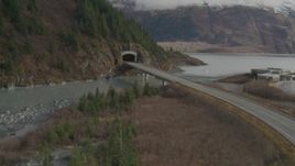 4K aerial stock footage follow Portage Glacier Highway approach mountain tunnel, Portage Lake, Alaska Aerial Stock Footage | AK0001_0390