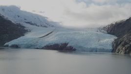 4K aerial stock footage flying by glacier, on the shore of Portage Lake, Portage Glacier, Alaska Aerial Stock Footage | AK0001_0393