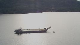 4K aerial stock footage approaching an anchored barge, reveal surrounding foothills, Shotgun Cove, Alaska Aerial Stock Footage | AK0001_0404