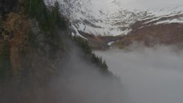 4K aerial stock footage fly above fog, approach Chugach Mountain peak, Prince William Sound, Alaska Aerial Stock Footage | AK0001_0416