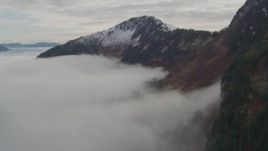 4K aerial stock footage flying over fog, approach Chugach Mountain ridge, Prince William Sound, Alaska Aerial Stock Footage | AK0001_0418