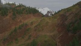 4K aerial stock footage fly low over rocky slopes, ridge, reveal snowy peaks, Prince William Sound, Alaska Aerial Stock Footage | AK0001_0422