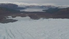 4K aerial stock footage flying over glacier with a view of the tree lined show, Prince William Sound, Alaska Aerial Stock Footage | AK0001_0451