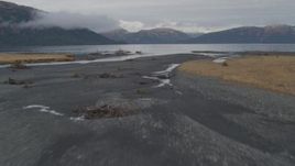 4K aerial stock footage fly low over river, shoreline, approach open water, Prince William Sound, Alaska Aerial Stock Footage | AK0001_0456