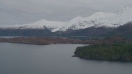 4K aerial stock footage flying by island, snow capped Chugach Mountains, Blackstone Bay, Alaska Aerial Stock Footage | AK0001_0483