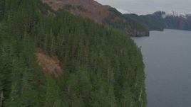 4K aerial stock footage flying along steep slope of a mountain peak on coast, Blackstone Bay, Alaska Aerial Stock Footage | AK0001_0490