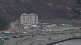4K aerial stock footage flying by an apartment building, train tracks, Whittier, Alaska Aerial Stock Footage | AK0001_0500
