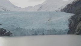 4K aerial stock footage flying by the edge of glacier on Portage Lake, Portage Glacier, Alaska Aerial Stock Footage | AK0001_0505